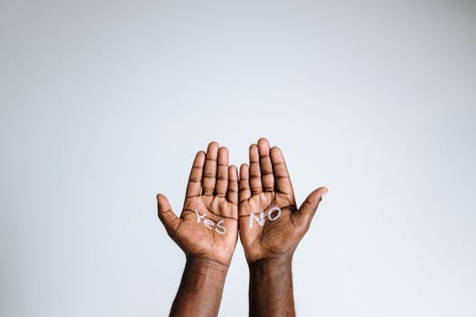Photo of open hands with 'Yes' and 'No' written on the palms, expressing choice and diversity.